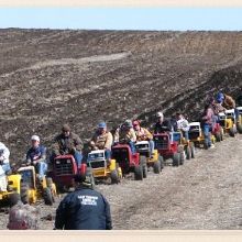 Land clearing tractor moving through a field during vegetation reduction work.